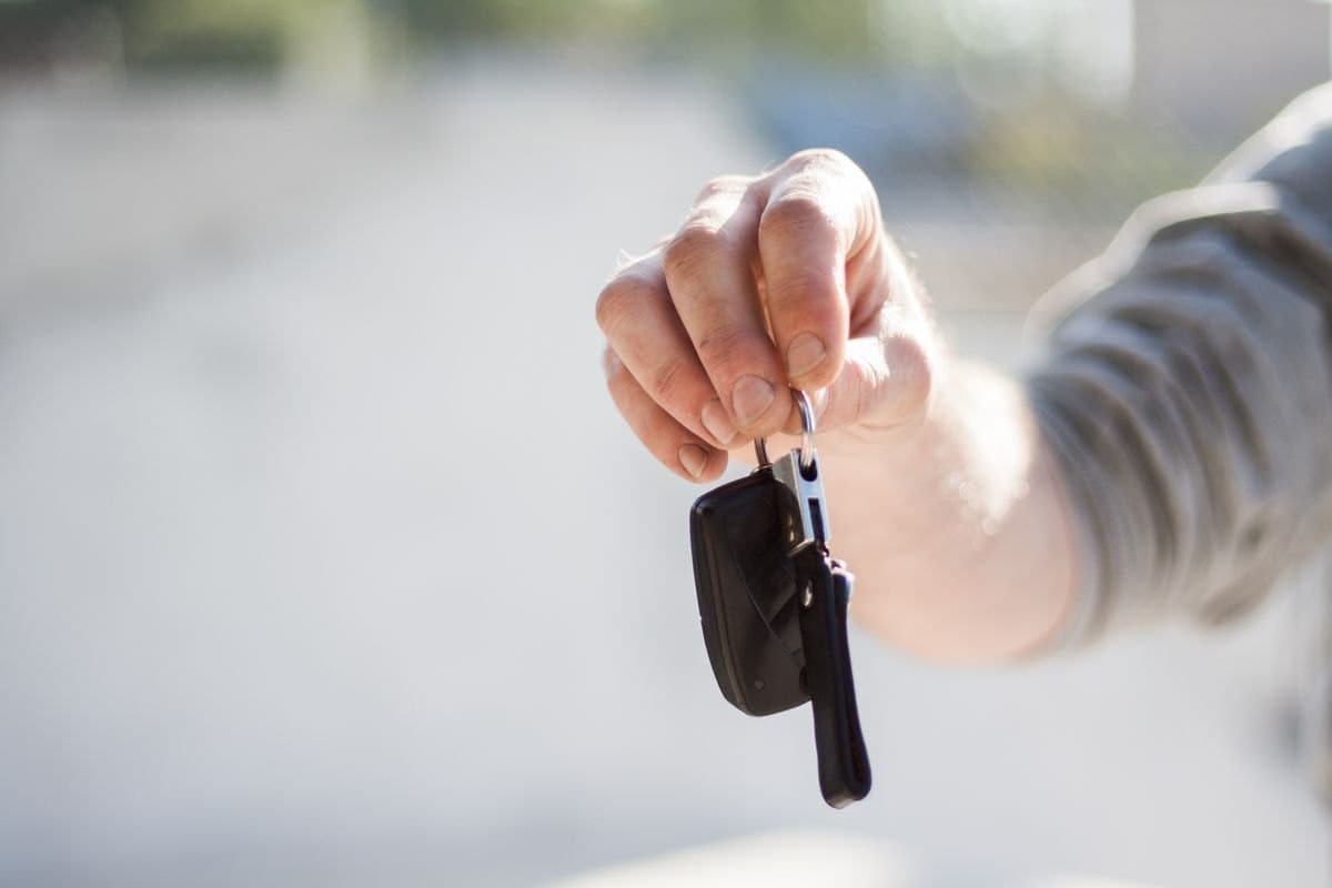 A hand holding car keys at turn-in